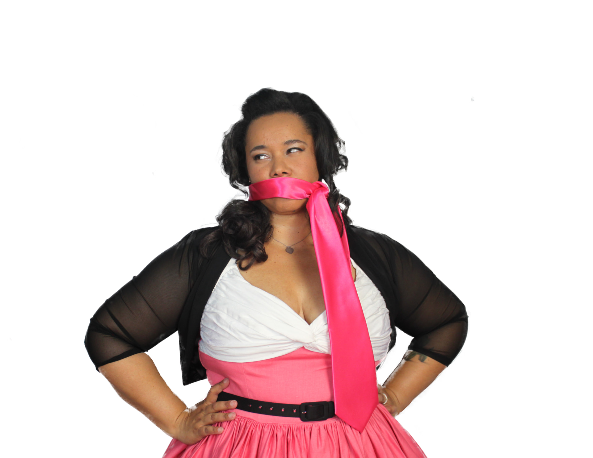 Veronica gagged with a pink tie that reads Pink Tie Magic